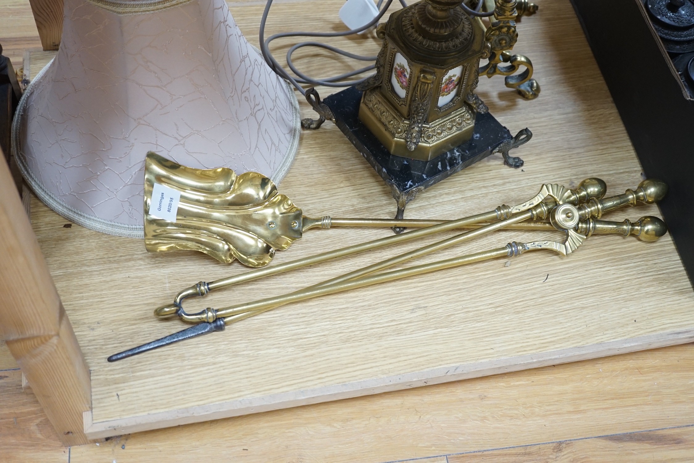 A brass table lamp and various fire implements